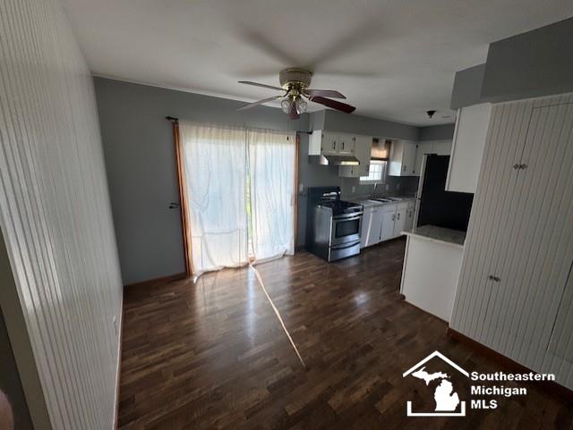 13091 Rosedale Blvd, Carleton, MI 48117 - kitchen featuring stainless steel stove, freestanding refrigerator, ceiling fan, white cabinetry, and dark wood-style flooring