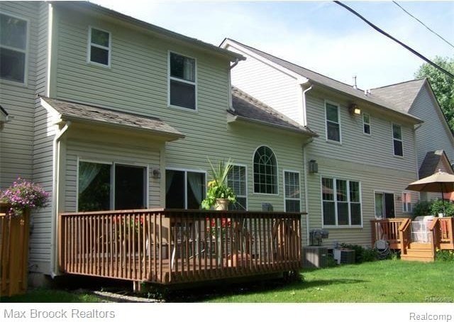 38351 Churchill, Farmington Hills, MI 48331 - back of property featuring a wooden deck and a lawn