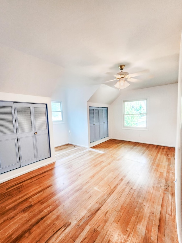 671 Lonesome Pine Trl, Saint Joseph, MI 49085 - unfurnished living room with light wood-type flooring, lofted ceiling, plenty of natural light, and ceiling fan