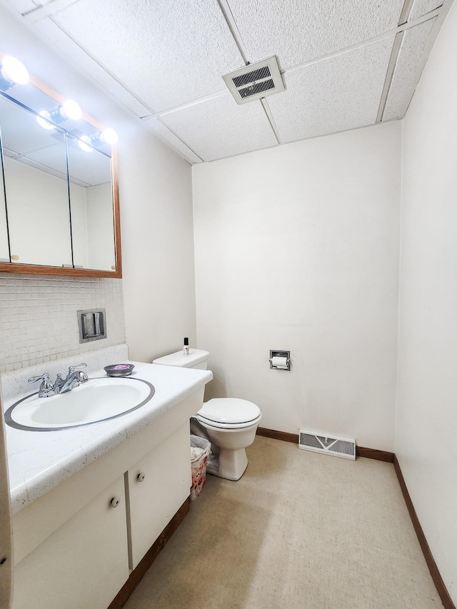 671 Lonesome Pine Trl, Saint Joseph, MI 49085 - half bath featuring vanity, decorative backsplash, and a drop ceiling