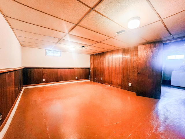 671 Lonesome Pine Trl, Saint Joseph, MI 49085 - basement featuring a paneled ceiling, washer / dryer, wooden walls, and a wainscoted wall