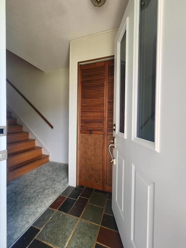 671 Lonesome Pine Trl, Saint Joseph, MI 49085 - entryway featuring a textured ceiling and stairs