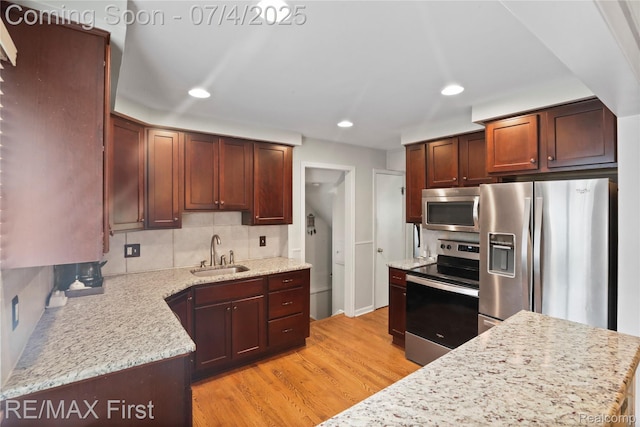 324 Fisher Rd, Grosse Pointe Farms, MI 48230 - kitchen featuring stainless steel appliances, light wood finished floors, decorative backsplash, recessed lighting, and light stone countertops