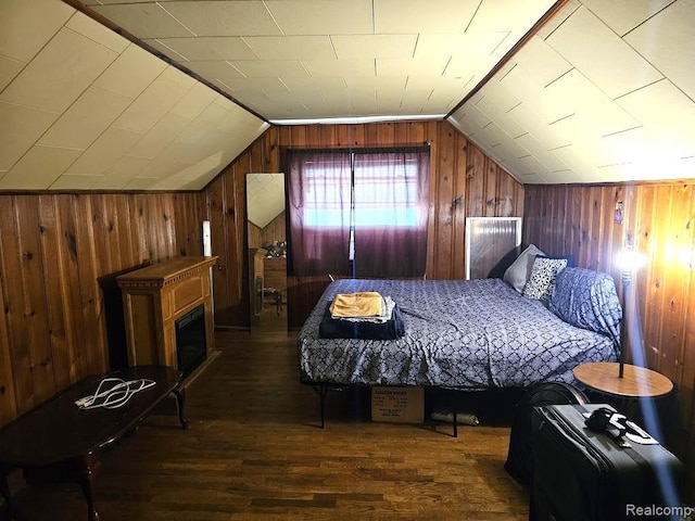 618 S Meade St, Flint, MI 48503 - bedroom featuring wood finished floors, wood walls, lofted ceiling, and a fireplace