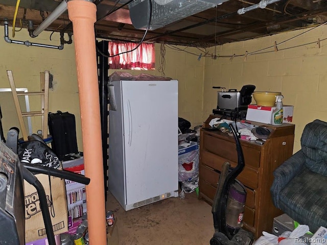 618 S Meade St, Flint, MI 48503 - below grade area featuring freestanding refrigerator and concrete block wall