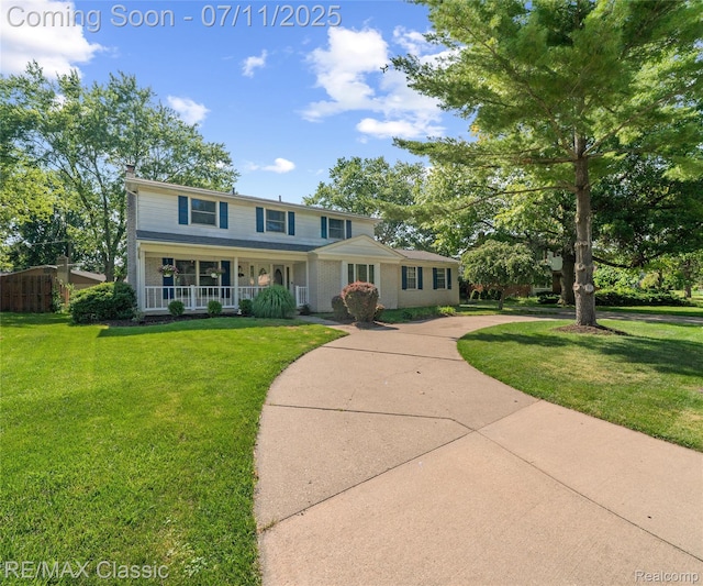 25067 Skye Dr, Farmington Hills, MI 48336 - view of front of property with a porch and a front lawn