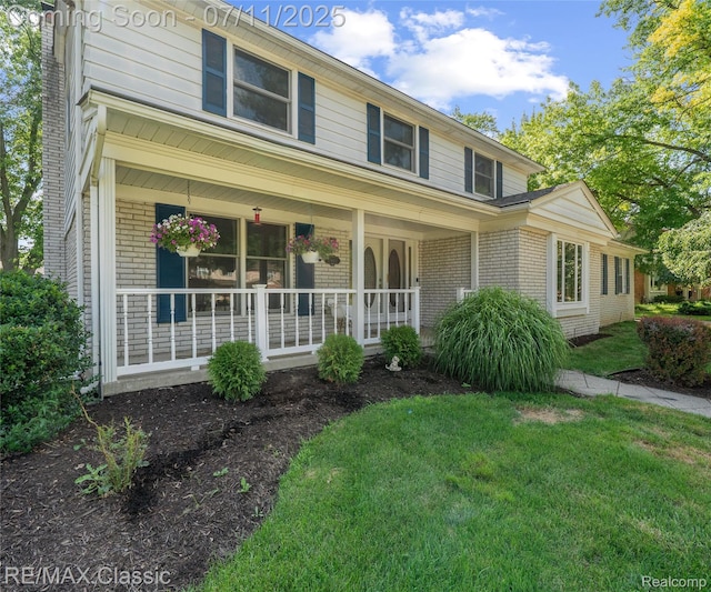 25067 Skye Dr, Farmington Hills, MI 48336 - view of front of property featuring brick siding, a porch, and a front yard