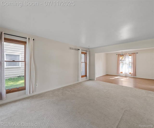 25067 Skye Dr, Farmington Hills, MI 48336 - empty room featuring carpet flooring and a chandelier