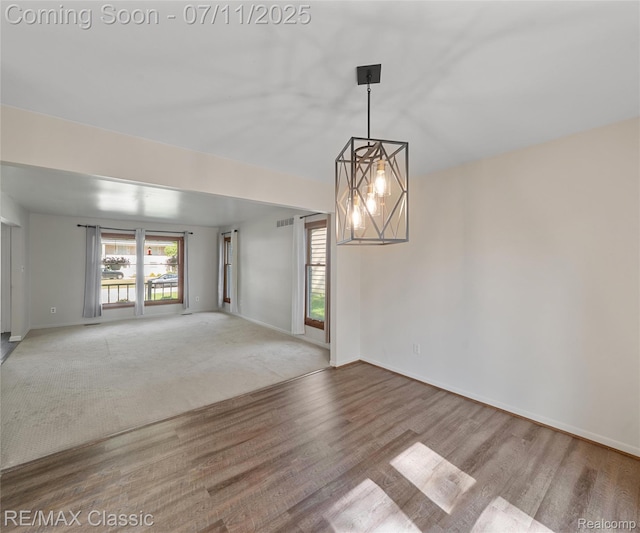 25067 Skye Dr, Farmington Hills, MI 48336 - empty room with wood finished floors and a chandelier