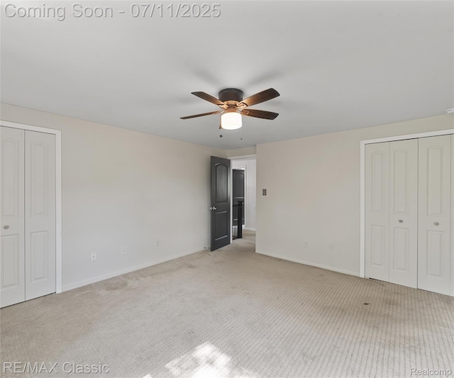 25067 Skye Dr, Farmington Hills, MI 48336 - unfurnished bedroom featuring light colored carpet, multiple closets, and ceiling fan