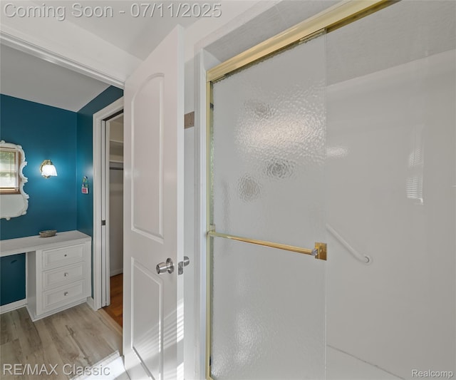 25067 Skye Dr, Farmington Hills, MI 48336 - bathroom featuring wood finished floors, a stall shower, and a walk in closet