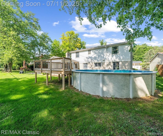 25067 Skye Dr, Farmington Hills, MI 48336 - back of property with a wooden deck, a yard, and an outdoor pool