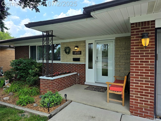 12137 Carol Ave, Warren, MI 48093 - property entrance with brick siding and covered porch