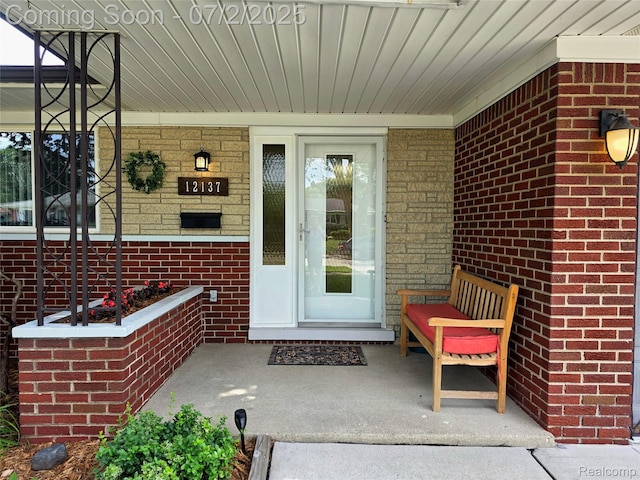 12137 Carol Ave, Warren, MI 48093 - doorway to property with covered porch and brick siding