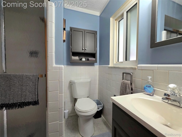 12137 Carol Ave, Warren, MI 48093 - full bathroom featuring a stall shower, tile walls, vanity, and wainscoting