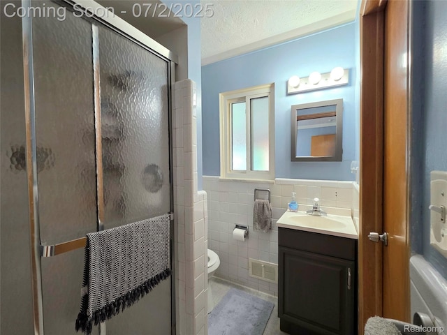 12137 Carol Ave, Warren, MI 48093 - full bath featuring tile walls, vanity, a stall shower, a wainscoted wall, and a textured ceiling