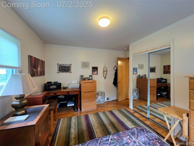 12137 Carol Ave, Warren, MI 48093 - bedroom featuring a desk, wood finished floors, a closet, and ornamental molding