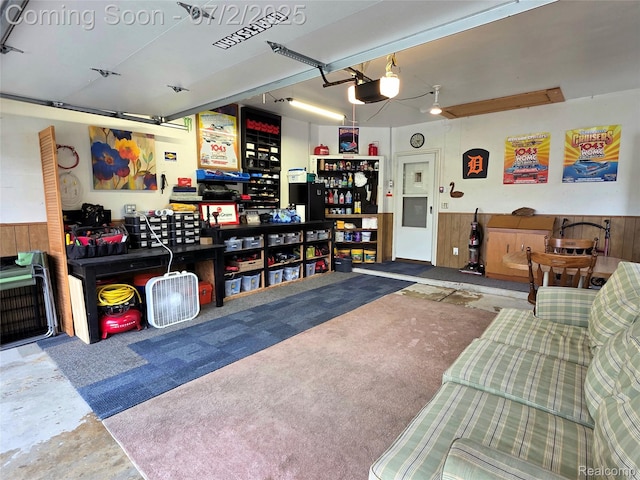 12137 Carol Ave, Warren, MI 48093 - garage with a garage door opener, a wainscoted wall, and wooden walls