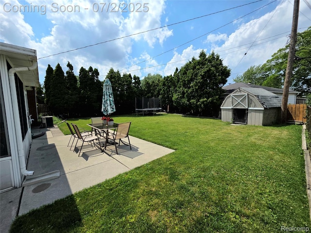 12137 Carol Ave, Warren, MI 48093 - fenced backyard featuring a trampoline, a patio, and a storage shed