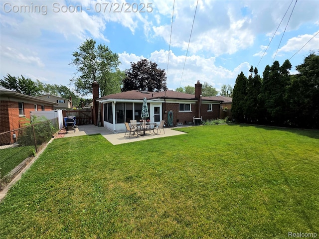 12137 Carol Ave, Warren, MI 48093 - back of house featuring a chimney, a patio area, a fenced backyard, and a sunroom