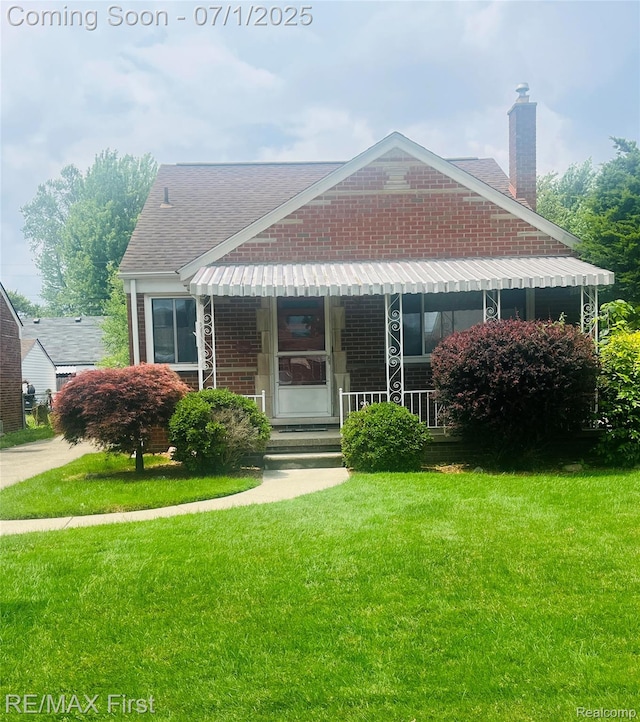 23015 Courtland Ave, Eastpointe, MI 48021 - view of front of property with a front yard, a porch, brick siding, a chimney, and a shingled roof