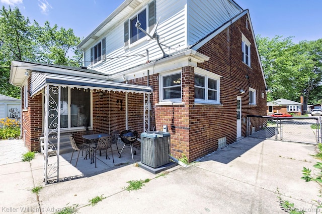17237 Philomene Blvd, Allen Park, MI 48101 - rear view of property featuring brick siding, a gate, and a patio