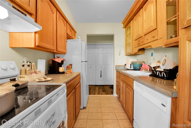 30028 W 12 Mile Rd Unit 27, Farmington Hills, MI 48334 - kitchen with white appliances, under cabinet range hood, glass insert cabinets, and light countertops