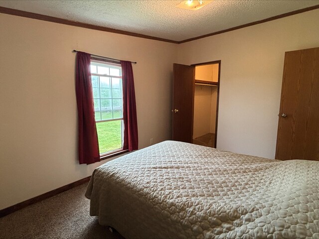 9670 Sayers Rd, Munith, MI 49259 - carpeted bedroom featuring crown molding and a textured ceiling