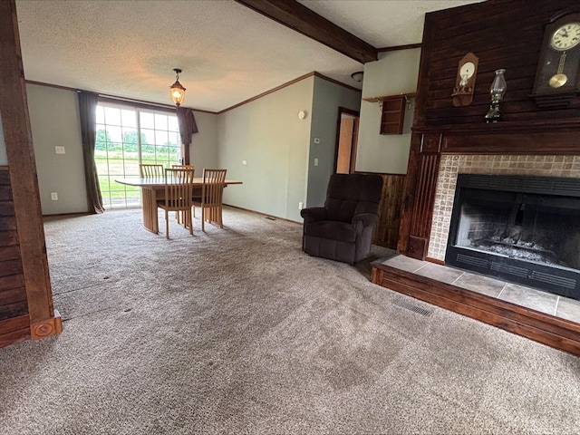 9670 Sayers Rd, Munith, MI 49259 - carpeted living room with ornamental molding, a textured ceiling, a fireplace, and beamed ceiling