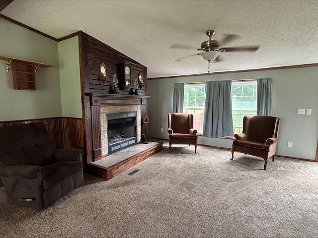 9670 Sayers Rd, Munith, MI 49259 - carpeted living area featuring crown molding, a fireplace, a textured ceiling, ceiling fan, and wooden walls