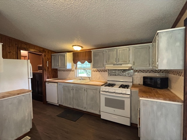 9670 Sayers Rd, Munith, MI 49259 - kitchen with white appliances, dark wood-style flooring, decorative backsplash, a textured ceiling, and under cabinet range hood