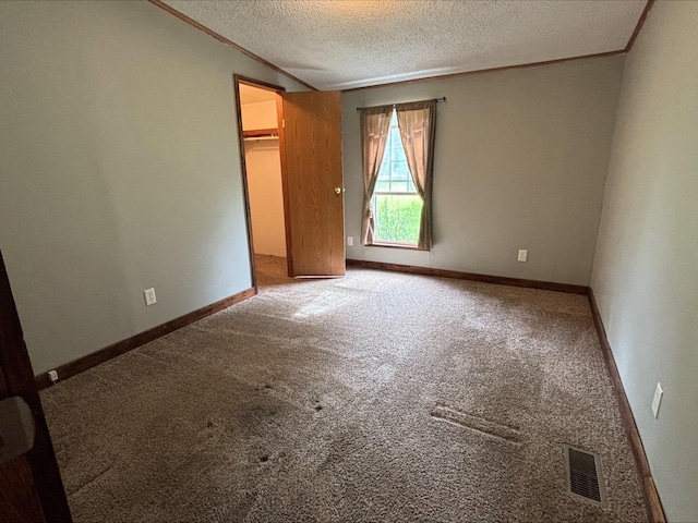 9670 Sayers Rd, Munith, MI 49259 - unfurnished bedroom featuring carpet flooring, crown molding, a spacious closet, a textured ceiling, and a closet