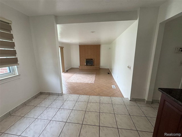 28240 Lahser Rd, Southfield, MI 48034 - unfurnished living room with light tile patterned floors and a brick fireplace