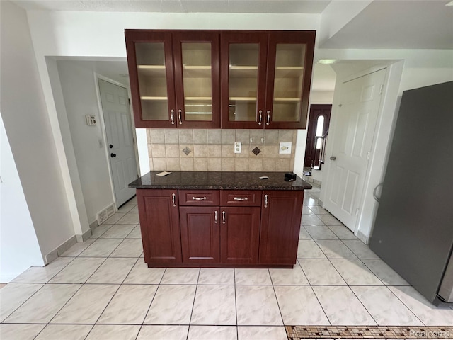 28240 Lahser Rd, Southfield, MI 48034 - kitchen featuring light tile patterned floors, glass insert cabinets, and tasteful backsplash