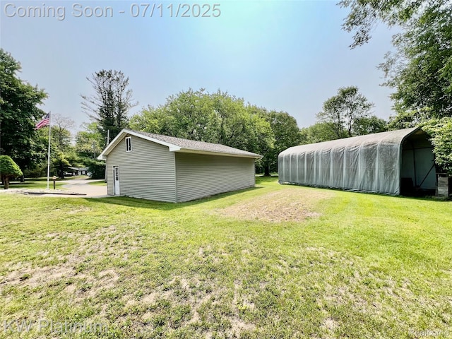 2243 Sunnyside Rd, Kimball, MI 48074 - view of grassy yard with an outbuilding and a carport