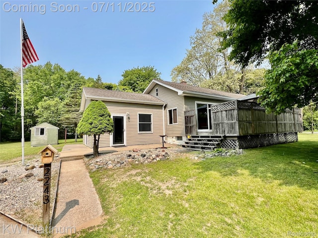 2243 Sunnyside Rd, Kimball, MI 48074 - back of house with a deck, a lawn, and a shed