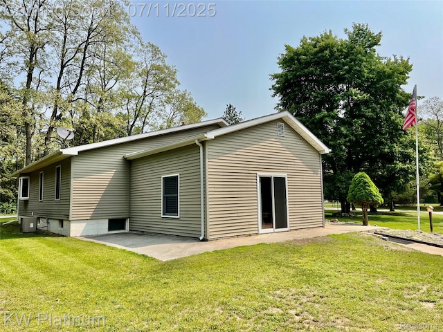 2243 Sunnyside Rd, Kimball, MI 48074 - back of property with a lawn and a patio