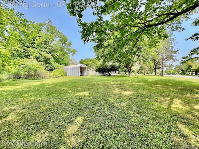 2243 Sunnyside Rd, Kimball, MI 48074 - view of green lawn featuring an outdoor structure and a pole building
