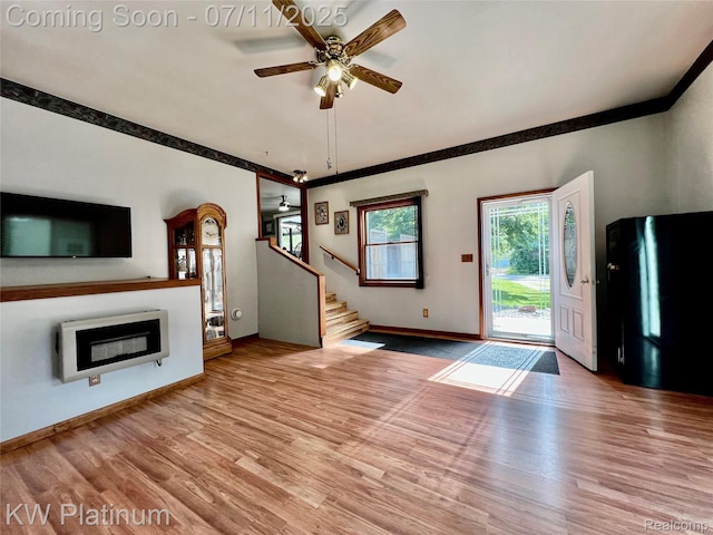 2243 Sunnyside Rd, Kimball, MI 48074 - unfurnished living room with a ceiling fan, wood finished floors, stairs, ornamental molding, and heating unit
