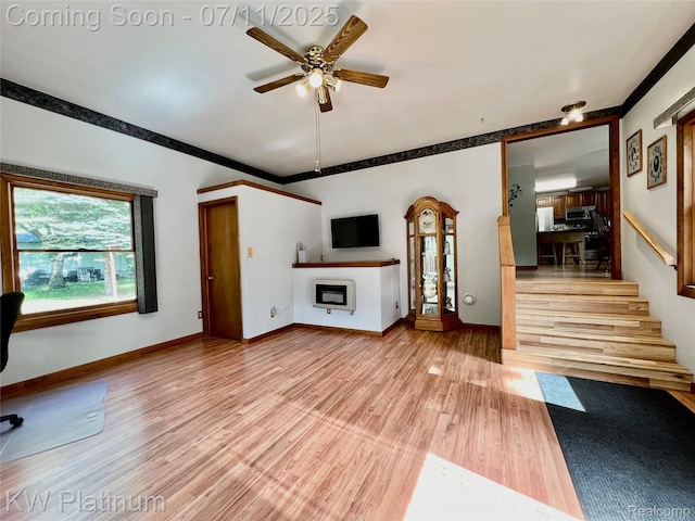 2243 Sunnyside Rd, Kimball, MI 48074 - unfurnished living room featuring light wood-style floors, a ceiling fan, stairs, and crown molding