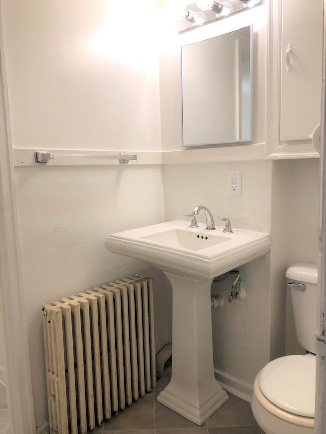 417 Oak St, Kalamazoo, MI 49007 - half bathroom with radiator heating unit and tile patterned flooring