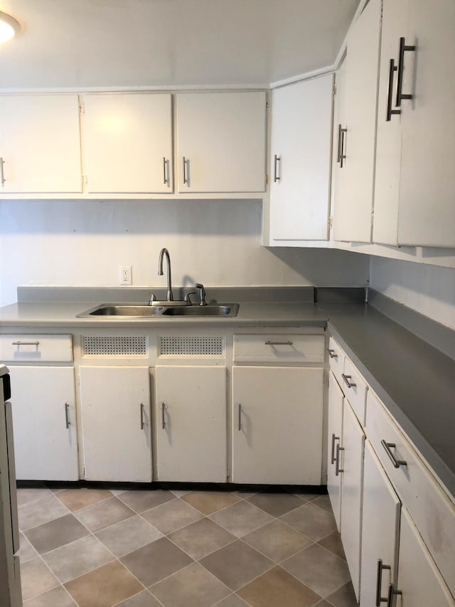 417 Oak St, Kalamazoo, MI 49007 - kitchen featuring white cabinets and tile patterned flooring