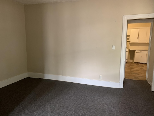 417 Oak St, Kalamazoo, MI 49007 - spare room featuring baseboards and dark carpet