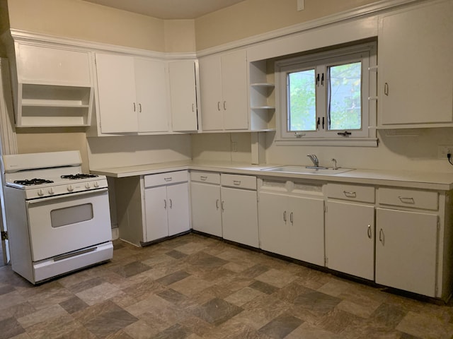 417 Oak St, Kalamazoo, MI 49007 - kitchen with white gas range, open shelves, light countertops, and white cabinets