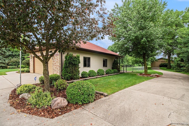 10363 E Bristol Rd, Davison, MI 48423 - view of front facade with driveway, an attached garage, and brick siding