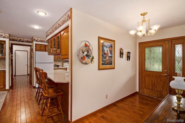 10363 E Bristol Rd, Davison, MI 48423 - entrance foyer with dark wood-type flooring and a chandelier