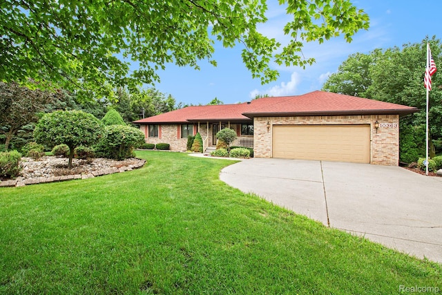 10363 E Bristol Rd, Davison, MI 48423 - single story home with driveway, a garage, a front lawn, and brick siding