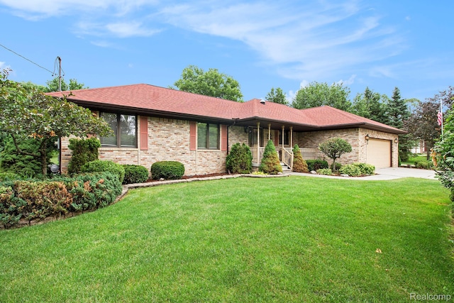 10363 E Bristol Rd, Davison, MI 48423 - ranch-style home featuring brick siding, concrete driveway, an attached garage, and a front yard