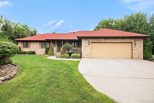 10363 E Bristol Rd, Davison, MI 48423 - ranch-style house featuring driveway, an attached garage, brick siding, a front yard, and covered porch