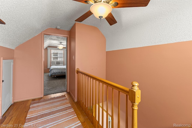 17729 Harman St, Melvindale, MI 48122 - hall with an upstairs landing, lofted ceiling, a textured ceiling, wood finished floors, and cooling unit